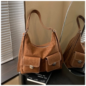 Detail of brown leopard print shoulder bag with dual front pockets and silver buckles