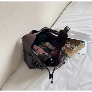 Top view of deep brown bucket bag interior showing capacity for daily essentials
