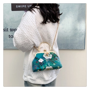 Detail view of the vintage floral silk qipao handbag with golden chain and bead clasp