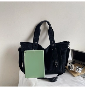 Large black tote bag shown with a laptop and headphones to demonstrate high capacity