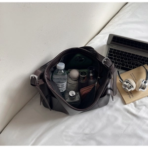 Detail view of deep brown large capacity tote bag showing spacious storage and knotted sides