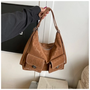 Detailed view of the brown leopard print suede tote bag with metal buckles and pockets