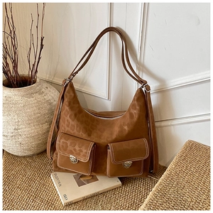 Macro detail of brown leopard print suede tote bag with silver buckle pockets on woven mat