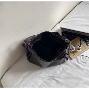Detail view of deep brown PU tote interior with spacious storage and side pocket