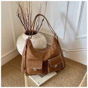 Detail of brown faux suede bag featuring leopard print and white contrast stitching