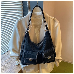 Detail of black leopard hobo bag with contrast stitching and dual buckle front pockets