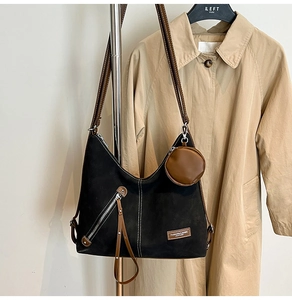 Black vintage hobo bag with brown leather straps and small coin purse attachment