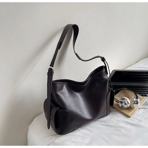 Detail of soft matte PU leather tote bag with adjustable strap and side pocket