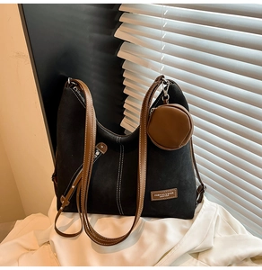 Detail of black matte tote bag with contrast stitching and leather label
