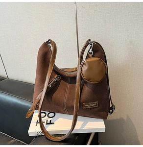 Detail of dark brown suede Hobo bag with visible stitching and mini round coin purse