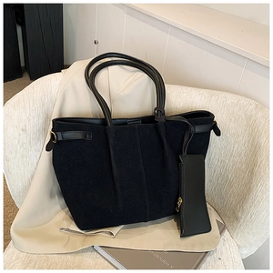 Détail du grand sac cabas en daim noir avec anses en cuir et petite pochette assortie