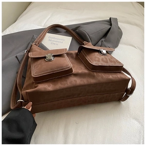 Detailed view of brown leopard print bag with silver metal buckles and contrast stitching