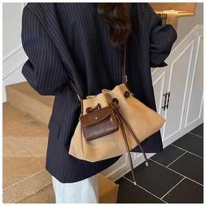 Detail of khaki suede bucket bag with dark brown leather drawstring and coin purse