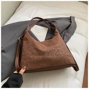 Detailed view of retro leopard print hobo bag with leather straps and contrast stitching