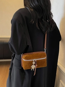 Brown vintage suede crossbody box bag with silver robot charm and tassel detail