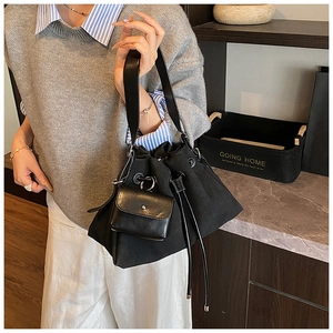 Detail of black canvas bucket bag with leather drawstring and matching coin purse