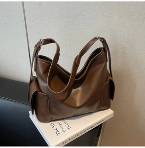 Detailed view of the dark brown PU leather hobo bag with side pockets and silver buckles