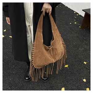 Detailed view of handmade fringe tote bag in vintage brown suede with woven edge details