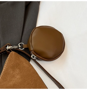 Close-up of retro brown leather tote with a matching round coin purse attachment
