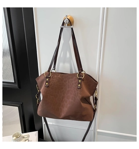 Detail of leopard print tote bag with gold hardware and removable shoulder strap