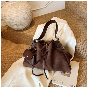 Detail of dark brown matte suede tote bag with drawstring and matching coin purse