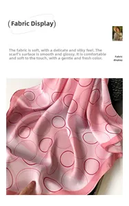 Detail of pink polka dot silk scarf showing smooth texture and soft glossy fabric finish