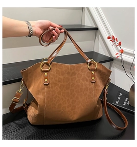 Detail of leopard print tote bag with gold ring hardware and brown adjustable strap