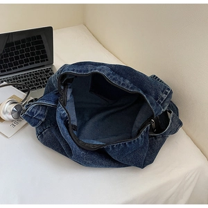 Interno dettagliato di borsa in denim blu con tasca con cerniera e ampio spazio
