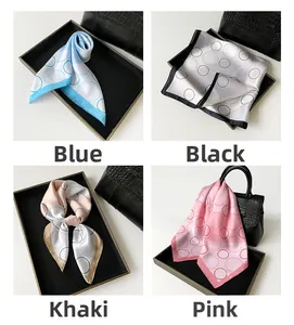 Detail of French polka dot silk scarves in blue, black, khaki, and pink colors