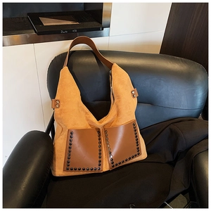 Detailansicht der senfgelben Wildledertasche mit braunen Ledertaschen und Nietenverzierung