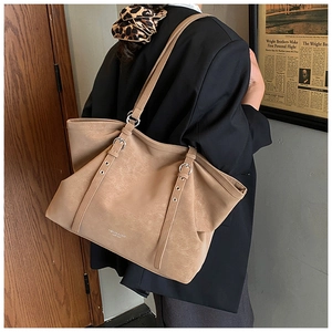 Detailed back view of a khaki suede tote bag with double straps and metal hardware