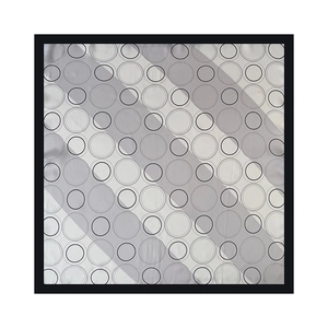 Detail of French minimalist polka dot pattern on silk scarf with black stitched edges