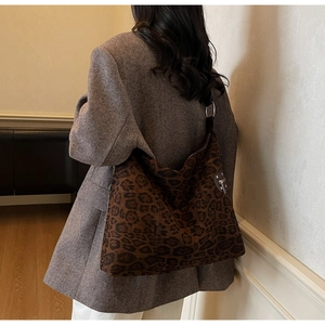 Detail view of large leopard print hobo bag showing soft velvet texture and metal zipper