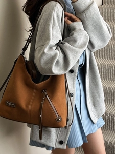 Brown vintage hobo tote bag in faux suede featuring exterior zipper and leather strap