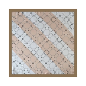 Detailed flat lay of beige silk scarf with black concentric rings and dark brown borders