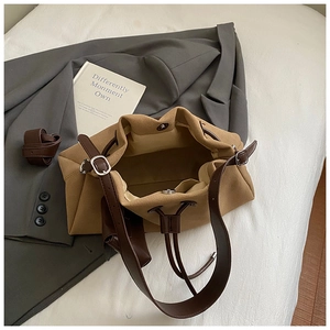 Overhead view of large brown suede tote bag with magnetic closure and inner pockets