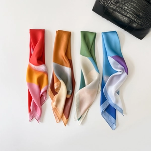 Selection of four geometric patterned silk scarves with soft metallic luster and satin finish