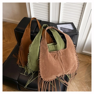 Three suede tassel tote bags in caramel, green, and khaki with bohemian fringe details