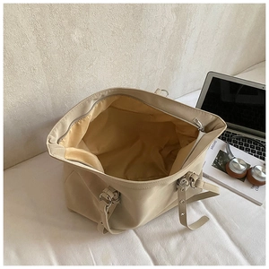 Interior view of beige tote bag with smooth satin lining and a zippered pocket
