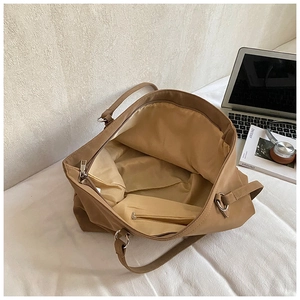 Detail view of brown tote bag interior featuring smooth lining and secure zipper pocket