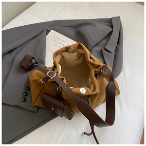 Top view of yellow bucket bag showing magnetic clasp, beige lining, and leather strap