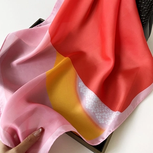 Vibrant oil-painting style silk scarf featuring red and yellow color blocks with floral patterns