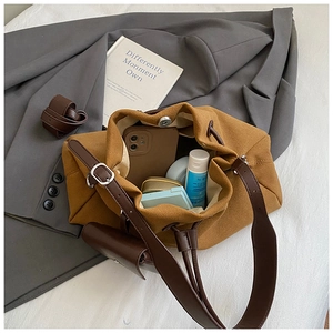 Top view of a large brown suede bucket bag showing spacious interior with daily essentials