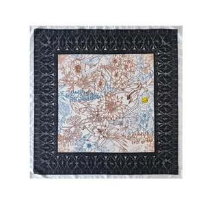 Detail showing elegant floral pattern and vintage silver scrollwork on square silk scarf
