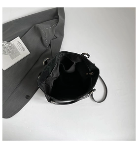 Top view of large black tote bag showing spacious interior with zipper pocket and metal rings