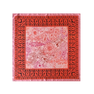 Detailed view of pink and orange floral patterns on smooth satin square scarf