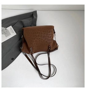 Detail shot of leopard print faux suede tote bag with leather strap and metal ring