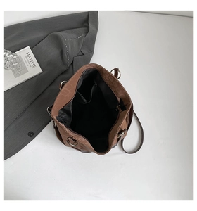 Interior detail of large brown tote bag showing dark lining and zippered pocket