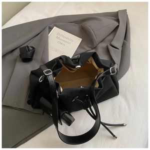 Internal view of black canvas tote bag with magnetic closure and small coin purse