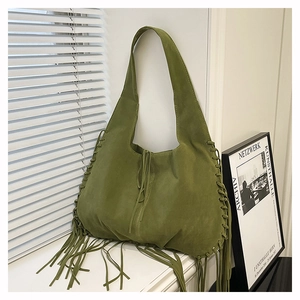 Detailed close-up of olive green suede tote bag featuring fringe and hand-stitched edges